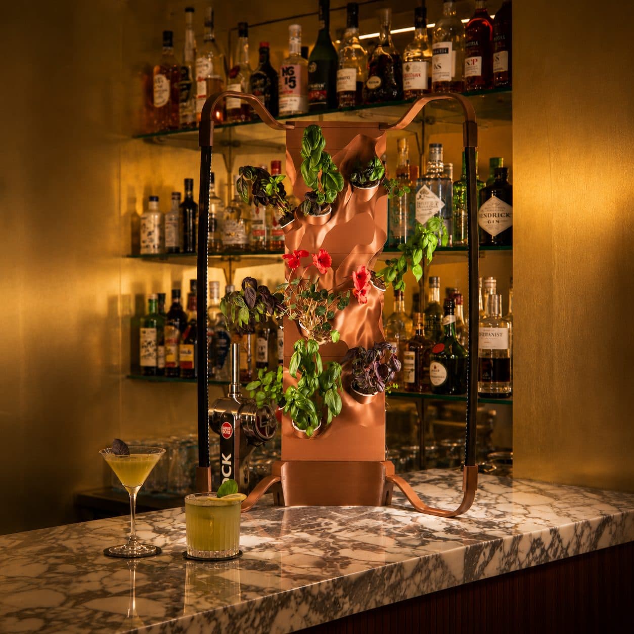 Copper Ortus on a marble bar counter with cocktails garnished from the garden
