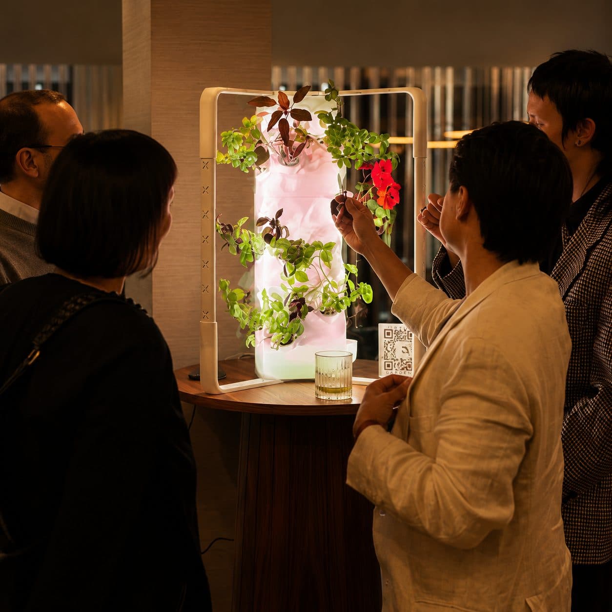 Guests gathered around a glowing Ortus in a hotel lounge
