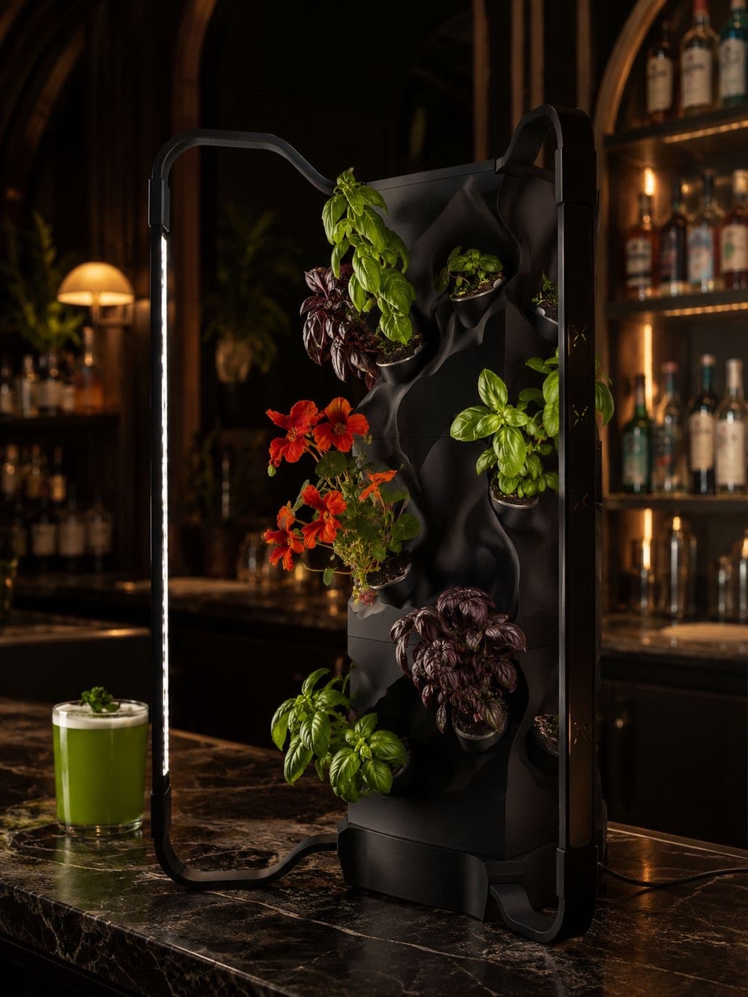 Black Ortus growing basil and nasturtiums on a marble bar top, beside a green cocktail